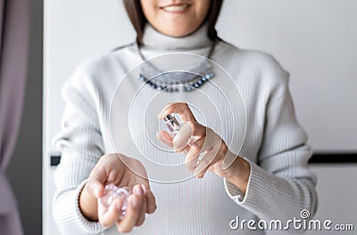 Beautiful asian woman hands spraying favorite perfume at home,Applying perfume is the simplest of matters Stock Photo