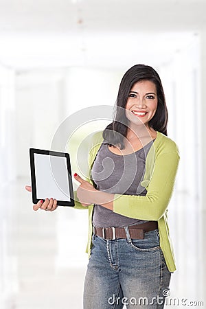 Beautiful asian woman holding a digital touch screen tablet comp Stock Photo