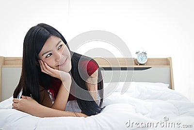 A beautiful Asian woman lounging in bed Stock Photo