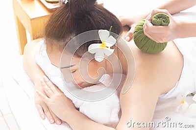 Beautiful asian woman lying massage treatment with happy mood on vacation day.Wellness body care and spa aromatheraphy concept Stock Photo