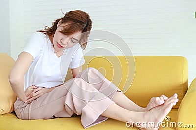 Beautiful Asian woman with right lower abdominal pain. Stock Photo