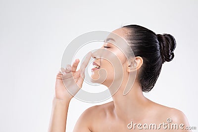 Beautiful Asian woman touching nose smile with clean and fresh skin Happiness and cheerful with positive emotional,isolated on whi Stock Photo