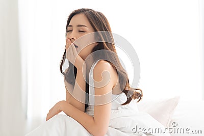 Beautiful Asian woman yawning Stock Photo