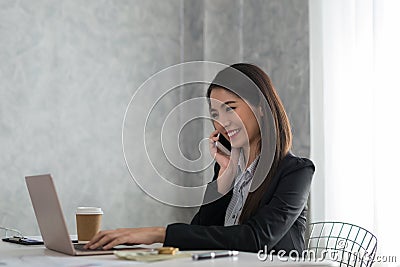 Beautiful asian young businesswoman working on laptop while be s Stock Photo