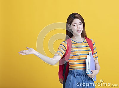 asian young student holding books and showing something Stock Photo