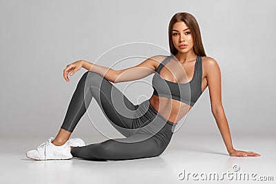 Beautiful athletic girl, fitness woman on gray background Stock Photo