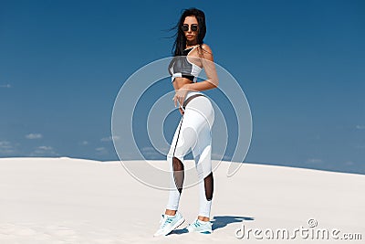 Beautiful athletic girl in sportswear, fitness woman in leggings outdoor Stock Photo