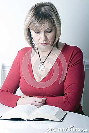 Beautiful attractive middle age woman reading Stock Photo