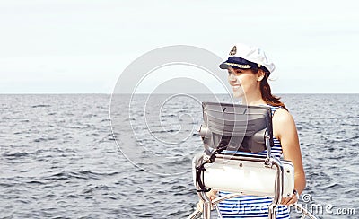 Beautiful, attractive sailor girl driving a boat. Sea, navigation concept. Stock Photo