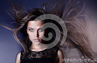 Beautiful attractive young Brazilian fashion model with hair blown by the air studio shot Stock Photo