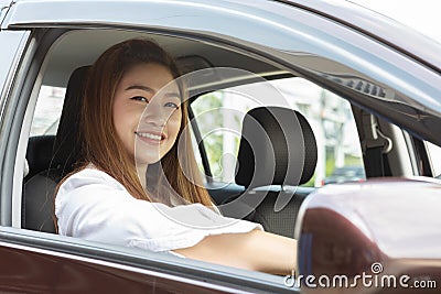 Beautiful attractive young woman smile in casual sitting in car Stock Photo