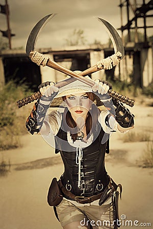 Beautiful attrctive agressive female warrior holding two swords Stock Photo