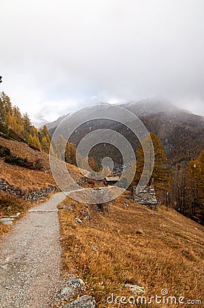 Beautiful autumn landscape with snow falling over a path towards Zermatt Resort Stock Photo