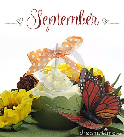 Beautiful Autumn Fall theme cupcake with autumn seasonal flowers and decorations for the month of September Stock Photo