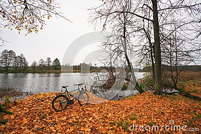 Beautiful autumn landscape with a river, a lone bicycle and fall Stock Photo