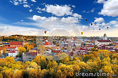 Beautiful autumn panorama of Vilnius old town with colorful hot air balloons in the sky Stock Photo