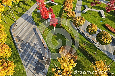 Beautiful autumn park with picturesque yellow orange trees and leaves. Autumn streets in city Dnipro, Ukraine Stock Photo
