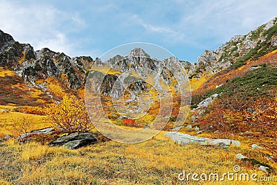 Beautiful autumn scenery of Senjojiki Cirque with rugged peaks in the background Stock Photo