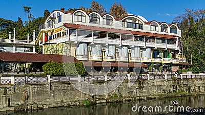 Beautiful autumn view of Sochi river. River embankment with buildings and trees. Sochi city center Editorial Stock Photo