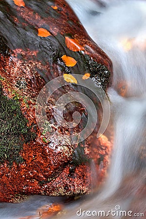 Beautiful autumn water between red stones Stock Photo