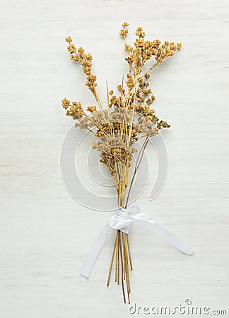 Beautiful Autumnal Easter Wedding Background. Dry Wild Flowers Tied with Silk Ribbon on White Wood. Minimalist Japanese Style Stock Photo