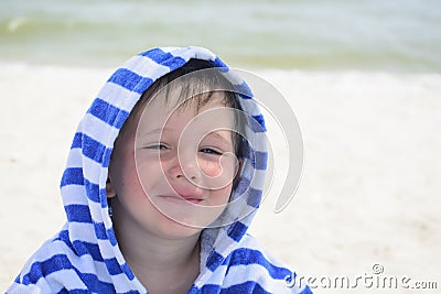 Beautiful baby with blue eyes on the sea background smiling, sweet and gentle. Cute child with atopic dermatitis on the background Stock Photo