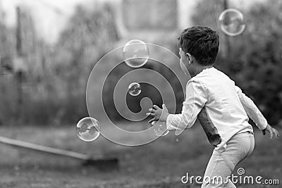 Beautiful baby boy with child soap bubbles posing photographer for cool photo Stock Photo