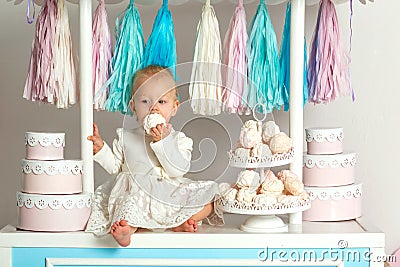 Beautiful baby girl sitting near the fabulous marshmallow house Stock Photo