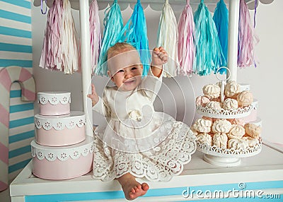 Beautiful baby girl sitting near the fabulous marshmallow house Stock Photo