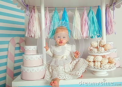 Beautiful baby girl sitting near the fabulous marshmallow house Stock Photo