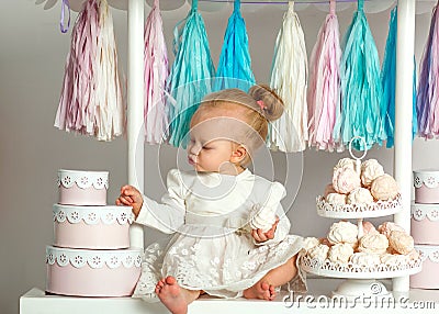 Beautiful baby girl sitting near the fabulous marshmallow house Stock Photo