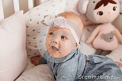 Beautiful baby girl Todler smiles in crib Stock Photo