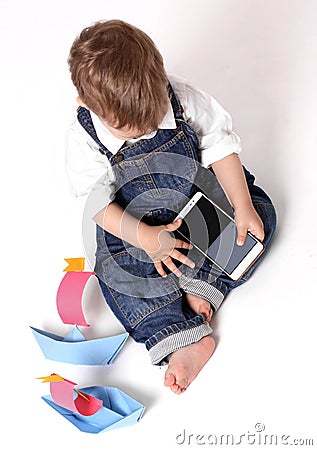 Beautiful baby playing with a smart phone isolated on a white background Stock Photo