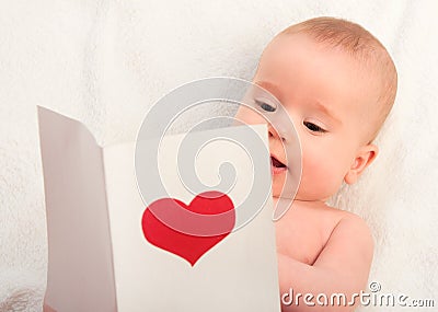Beautiful baby and postcard Valentine's Day with a red heart Stock Photo