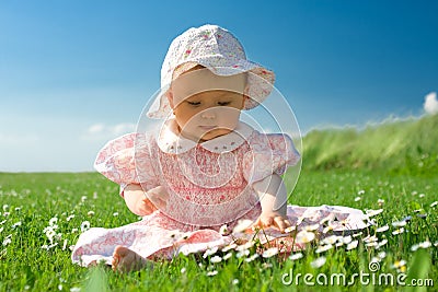 Beautiful baby sat in field Stock Photo