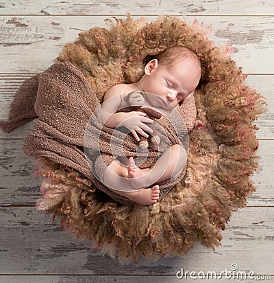 Beautiful baby sleeping sweet on fluffy round cot Stock Photo