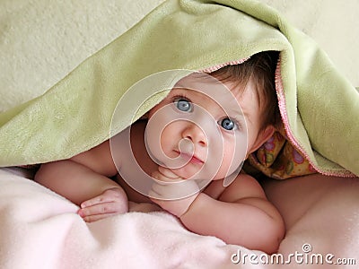 Beautiful baby under blanket Stock Photo