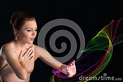 The ballerina in pointes and a dress sensually slightly touches Stock Photo