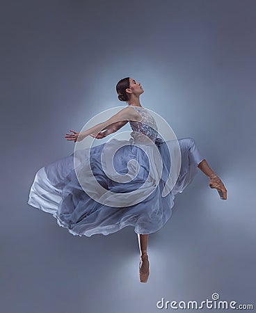 The beautiful ballerina dancing in blue long dress Stock Photo