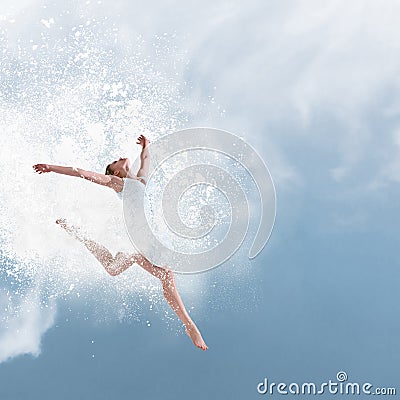 Beautiful ballet dancer jumping with cloud of powder Stock Photo