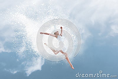 Beautiful ballet dancer jumping inside cloud of powder Stock Photo