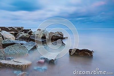 Beautiful Baltic sea landscape with stone breakwater. Tranquil long exposure landscape Stock Photo