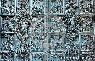 Beautiful bas-reliefs on the bronze door of building of the Milan Cathedral Duomo di Milano, the cathedral church of Milan, Stock Photo