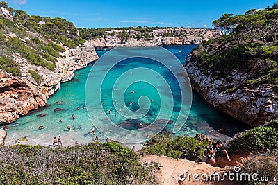 A beautiful bay with clear blue water and a lot of swimmers on mallorca, spain Editorial Stock Photo