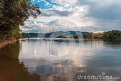 Beautiful bay on the Czorsztyn Lake. Mountain landscape. Sailboats moored in a small marina. Czorsztyn, Poland Stock Photo