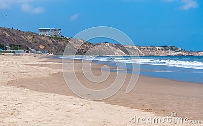 Beautiful Beach with people, birds, buildings and para gliders Stock Photo
