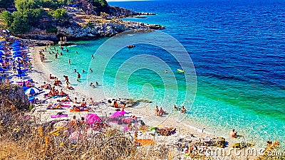 Beautiful Beach with people on the sand enjoing water and sun Editorial Stock Photo