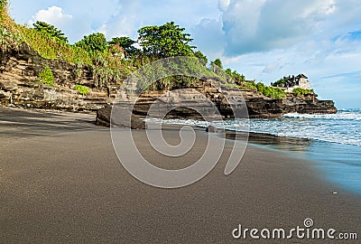 Beautiful beach and Pura Batu Bolong temple on Bali, Indonesia. Stock Photo