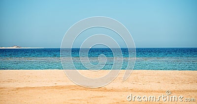 Beautiful beach with sand, blue sky, water with boat Stock Photo