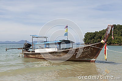 Beautiful beach with sea views and a traditional Thai fishing boat.Beautiful beach with tropical trees with a wave of the sea and Editorial Stock Photo